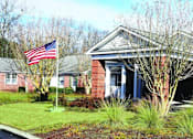 Thumbnail 5 of 5 - a building with an flag in front of it