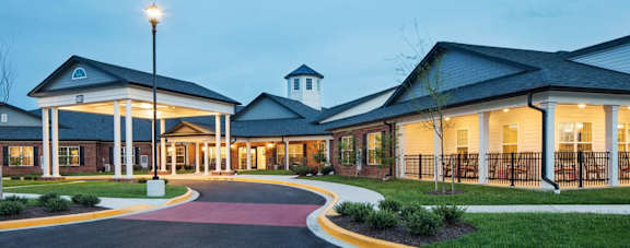 a rendering of the exterior of a hospital building at dusk