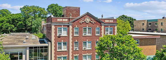 A red brick building with a clock on the front.