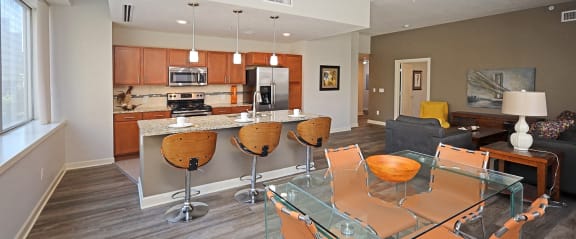 a kitchen and dining room with a glass table and chairs