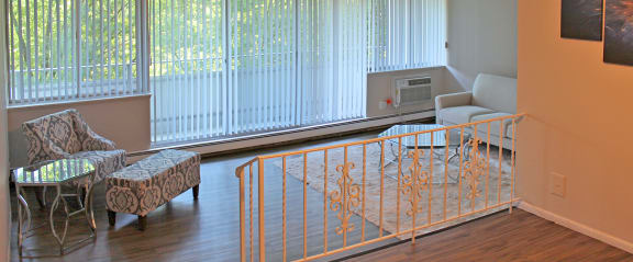 a baby crib in a living room with a couch and chairs