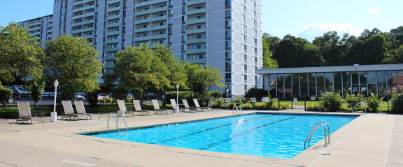 a swimming pool in front of an apartment building