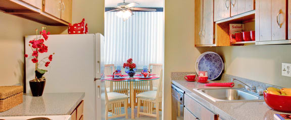 a kitchen with a dining table and a refrigerator