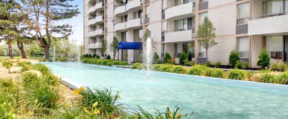 a large swimming pool in front of an apartment building