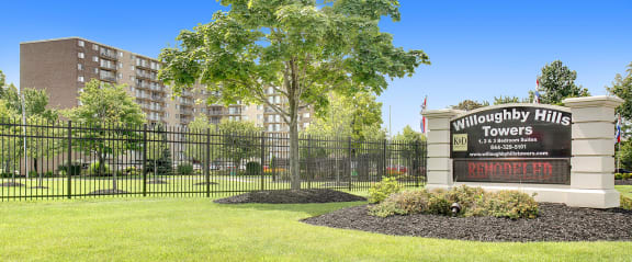 the preserve at bridgewater hills apartments sign in front of fence and tree