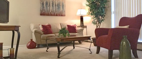 a living room with a couch and chairs