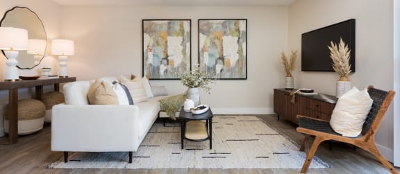 a living room with a white couch and a black coffee table