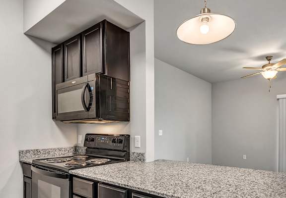 the kitchen of a home with a granite counter top