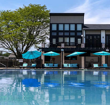 a swimming pool with a building in the background
