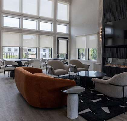 a living room with couches and chairs and a fireplace