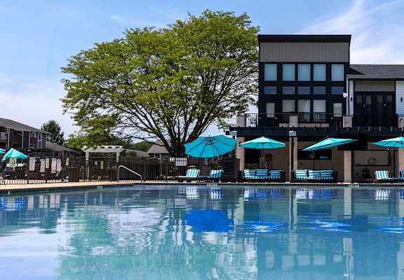 a swimming pool with a building in the background
