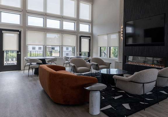 a living room with couches and chairs and a fireplace