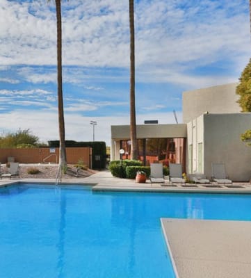 Springhill Apartments Community Pool with lounge chairs around.