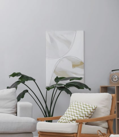 A living room with a white couch, a wooden chair, a wooden table, and a potted plant.