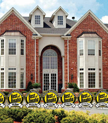 the front of a brick building with chairs in front of it