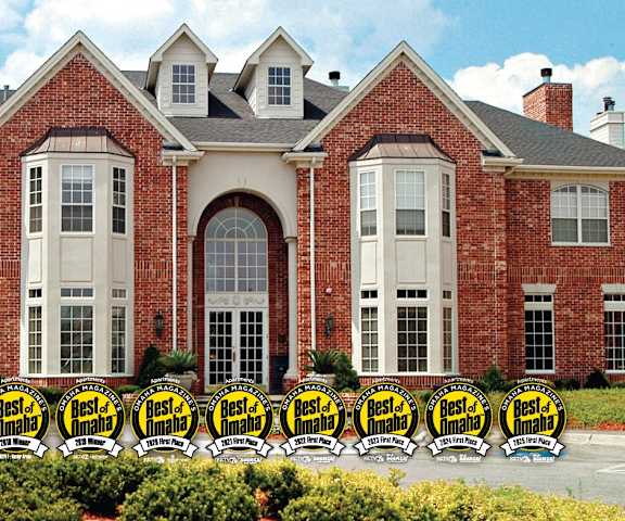 the front of a brick building with chairs in front of it