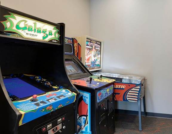 A room with several arcade games including a Caligula game at Era on Excelsior, St. Louis Park, Minnesota
