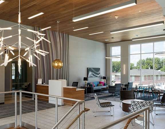 A modern interior with a reception desk and a staircase at Era on Excelsior, St. Louis Park, Minnesota
