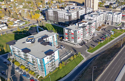 an aerial view of a city with buildings and a highway