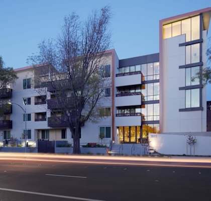 A modern building with a curved road in front of it.