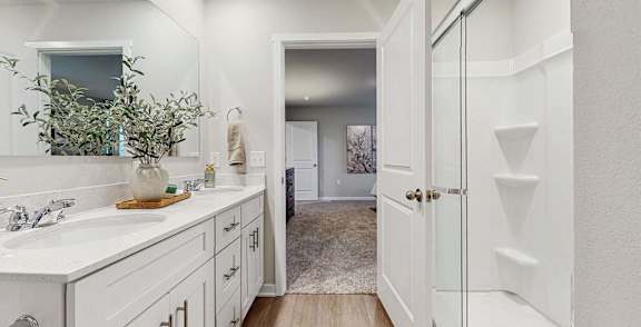A bathroom with a white sink and a white door.