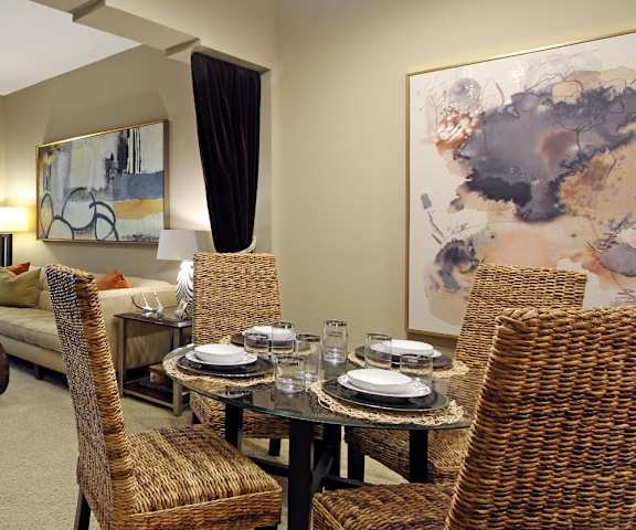 A living room with a dining table set for four.