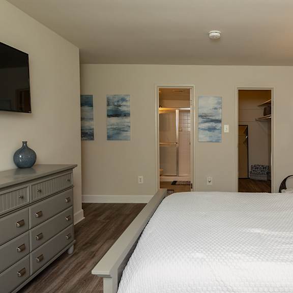 a living room with a blue couch and a tv at Deer Park Apartments, Maryland