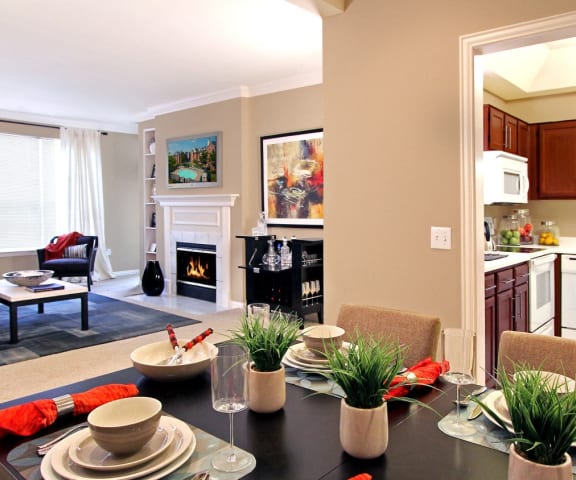 a living room and kitchen with a dining room table and chairs