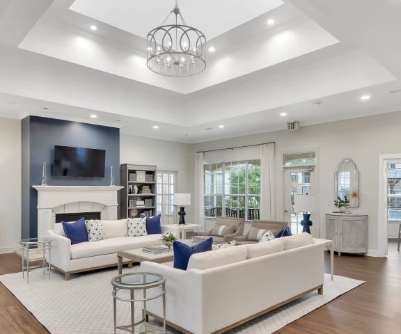 a living room filled with furniture and a large chandelier at Ashford Place Apartment Homes, Flowood, Mississippi