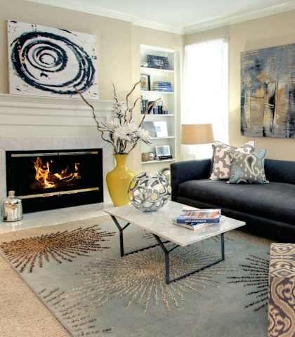 a living room with blue couches and a fireplace