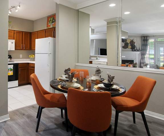 A kitchen with a dining table set for four.