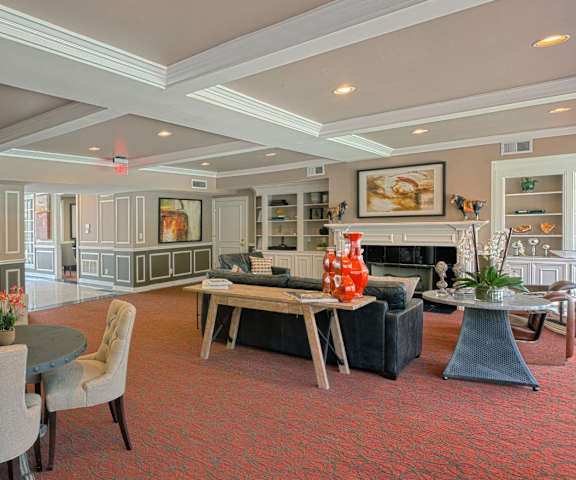 a living room with a table and chairs and a fireplace