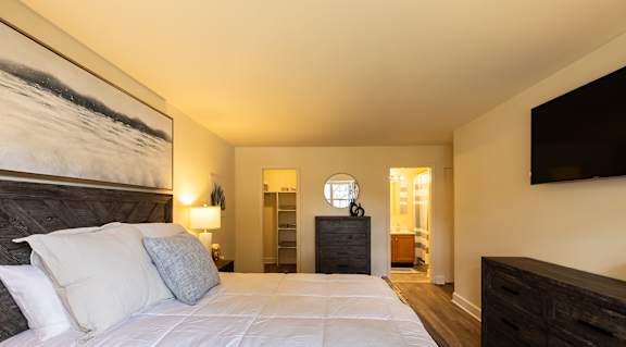 Bedroom with a bed and lamps on the wall at Woodridge Apartments, Randallstown, 21133