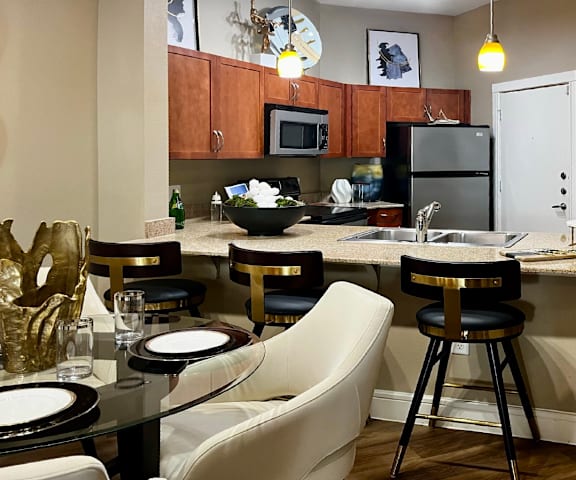 A kitchen with a table and chairs set for two.