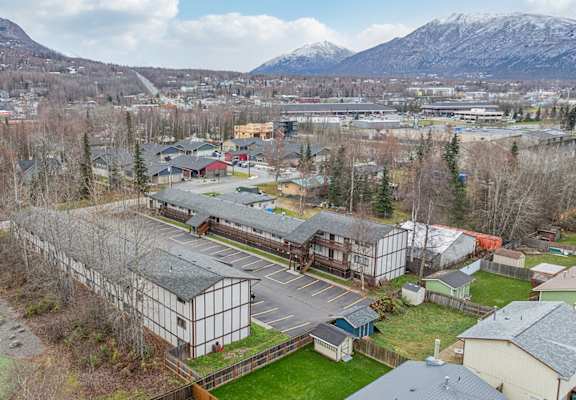 A parking lot with a mountain in the background.