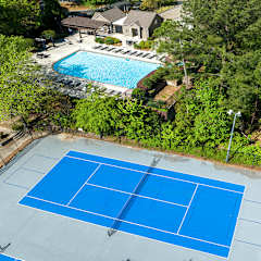 an aerial view of a tennis court and pool