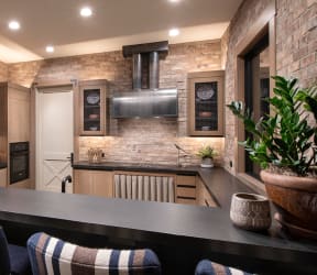 a kitchen with a large island with a marble countertop