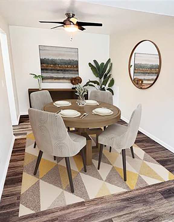 A dining room with a table and chairs.