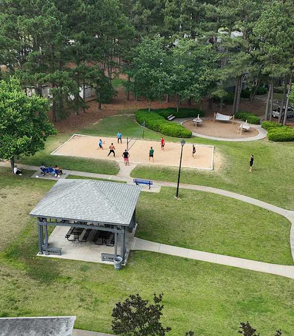 a park with a playground and a pavilion      and trees