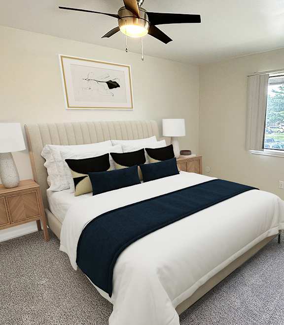 A bedroom with a bed, nightstand, and window.