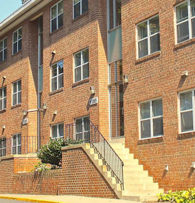 a large brick building with a staircase in front of it
