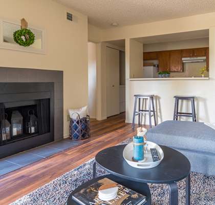 Enclave living room with cozy couches and wood flooring