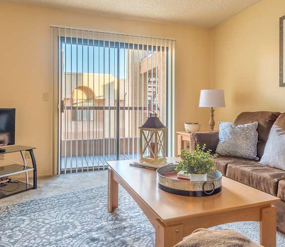 Sycamore Creek Large Living Room with large couch and access to balcony
