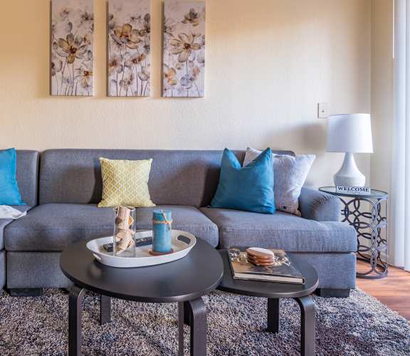 Enclave living room with cozy couches and wood flooring