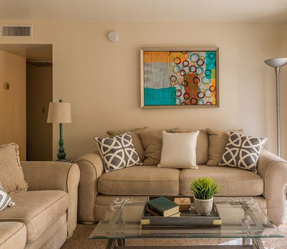 Cantera living rooms with private balconies and sliding glass door