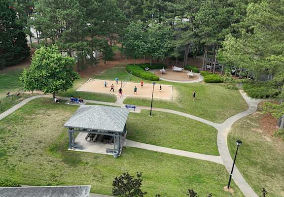 a park with a playground and a pavilion      and trees