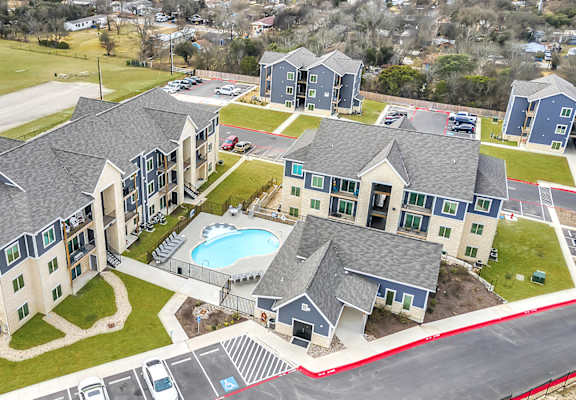 an aerial view of a large house with a swimming pool