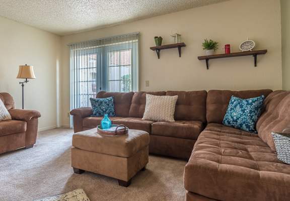 Somerpointe living room with plenty of couches and lounging space with carpet flooring