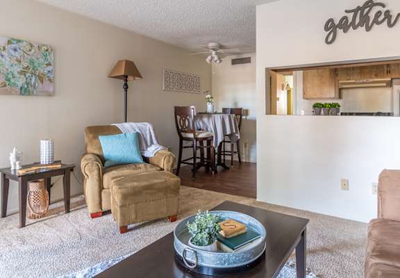 Foothills living room with carpet flooring and cozy couches and chairs