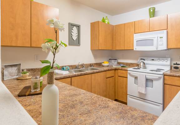 Desert Sands kitchen equipped with all white appliances.